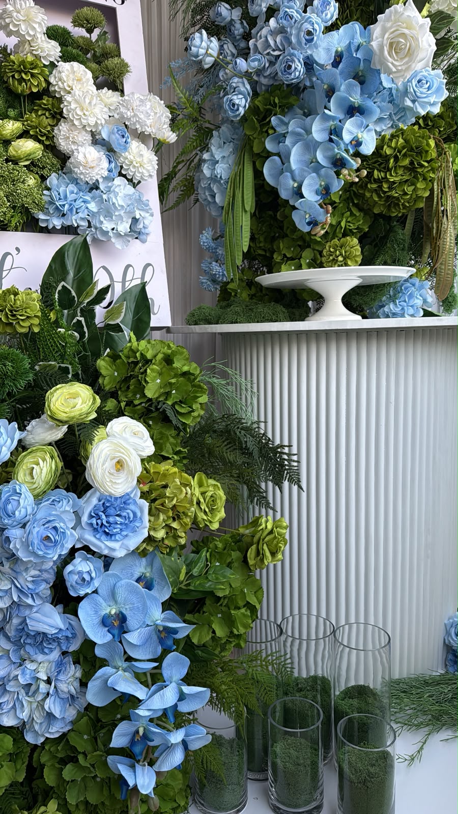 Milestone birthday styling in blue and green garden tones with orchids and roses