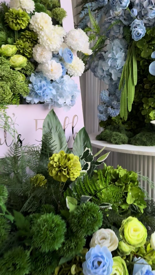 Blue, green and white floral backdrop with personalised 50th birthday signage