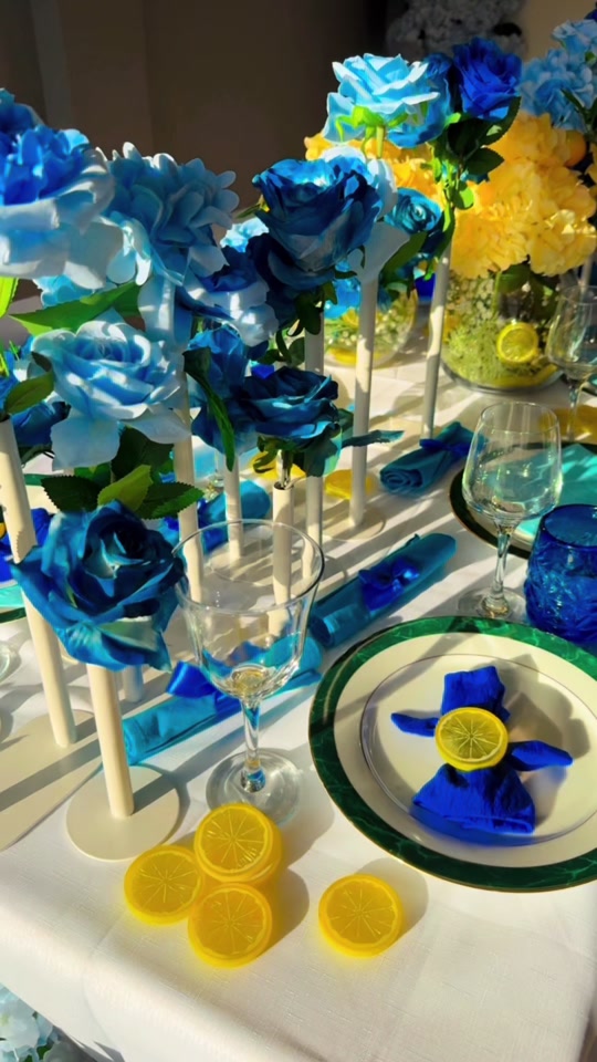 Baby shower tablescape with blue roses, yellow florals and lemon accents