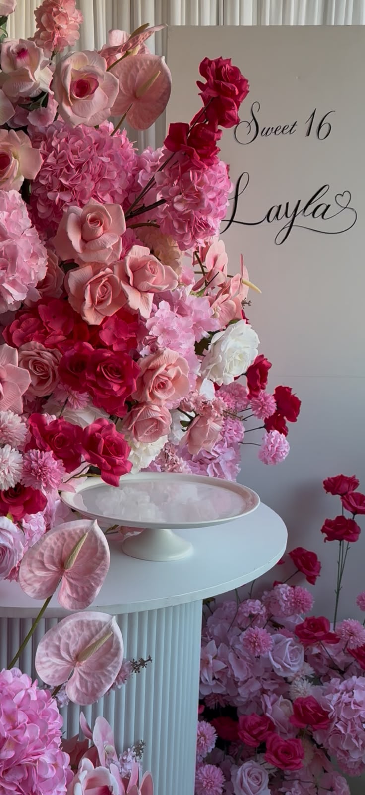 Sweet sixteen styling in blush and rose tones with floral installation and calligraphy signage